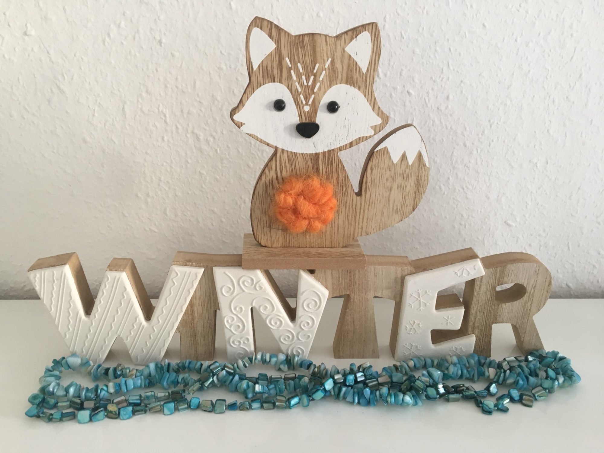 Holz Logo von einem Fuchs vor dem Schriftzug "Winter"